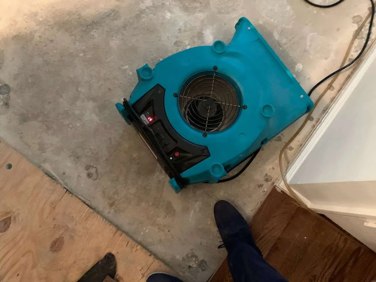 Air mover drying subfloor during Commercial Water Damage Restoration in Sioux City